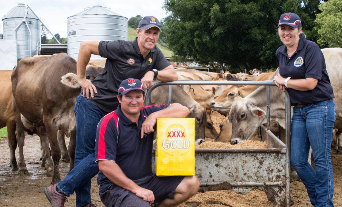 BY PRODUCTS: Lion suppliers, Ray and Catherine De Vere, who farm west of Nambour on Queensland's Sunshine Coast, with their cows sampling brewers' grain from Lion's XXXX brewery, and Lion farm services officer, Cameron Whitson, poised to shout everybody a beer.