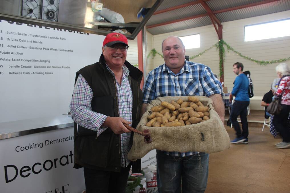 GOLDEN HARVEST: The first box of Crookwell's Gold potatoes were auctioned for $1000 at the annual Crookwell Potato Festival. Half of the proceeds will go towards the Upper Lachlan Shire Trust, and return into the community. Photo: Mariam Koslay. 