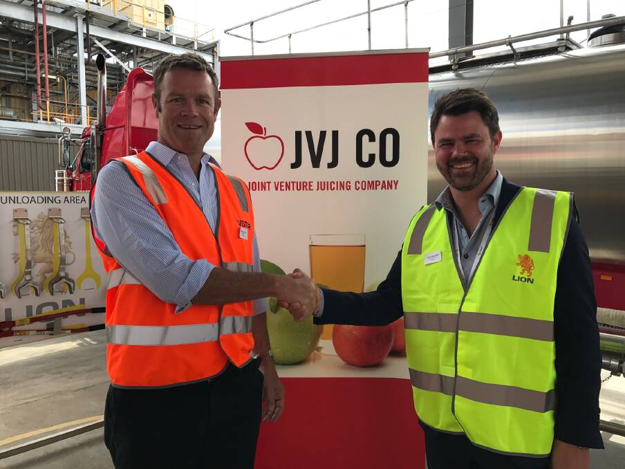 DONE DEAL: JVJ Co CEO Fergus McLachlan seals the deal with Lion brewery director Lars Christensen. 