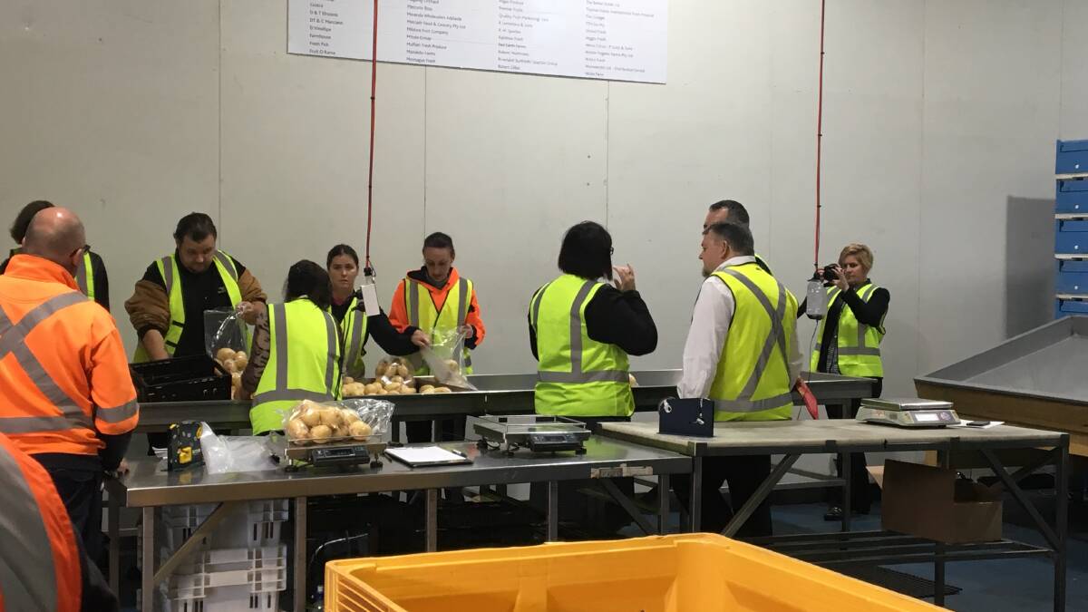 PRODUCTION LINE: The Foodbank SA team showing how the group gets food ready for those in need. 