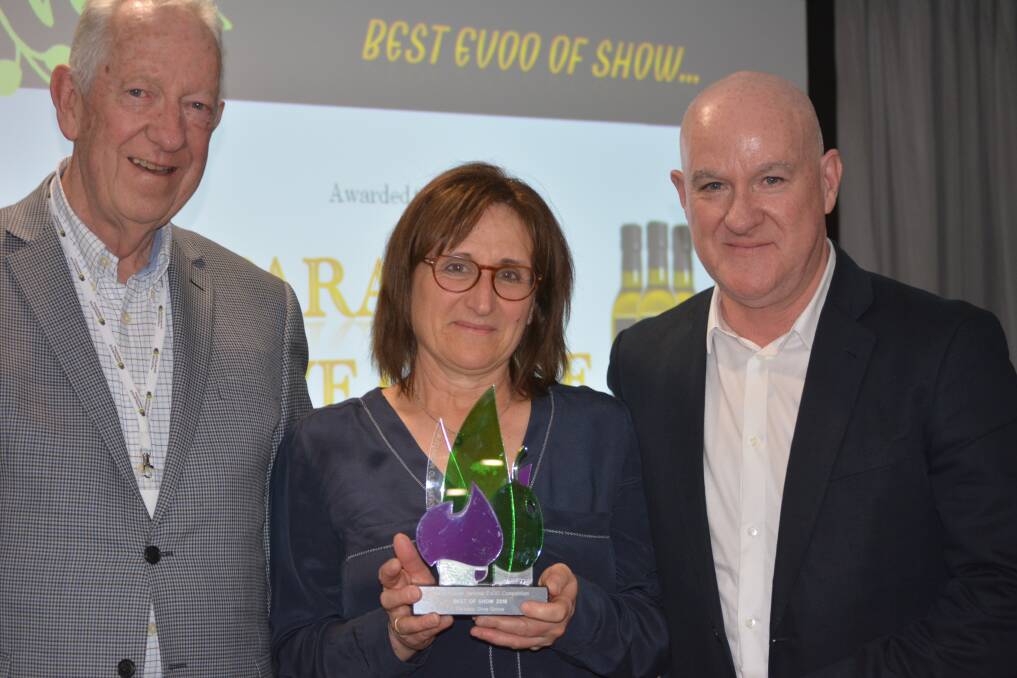 GOOD OIL: Australian Olive Association president Peter O’Meara presents Paradox Olive Grove owners David and Michele Sheward, Kunumbra, Victoria with the Best of Show award at this year’s Australian Olive Association National Extra Virgin Olive Oil Competition.  