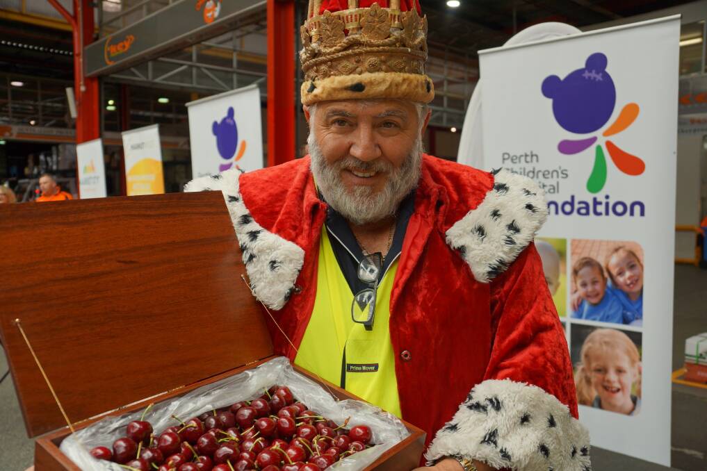 ALL HAIL: Tony Ale of Tony Ale and Co, shows of his newly earned crown and cherries after becoming the 2017 Cherry King at the Market City Charity Cherry Auction this month. 