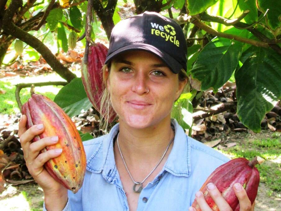 James Cook University graduate student Samantha Forbes from the Centre for Tropical Biodiversity and Climate Change with cocoa pods as part of her research into how sustainable farming practices can encourage pollination and natural pest control.