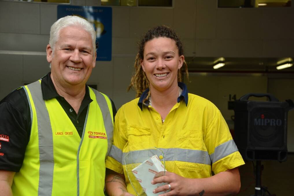 Winner of Perth's Market City Toyota Forklift Challenge, Kirstie Downie accepting the trophy from Toyota Perth branch manager Lance Cross.