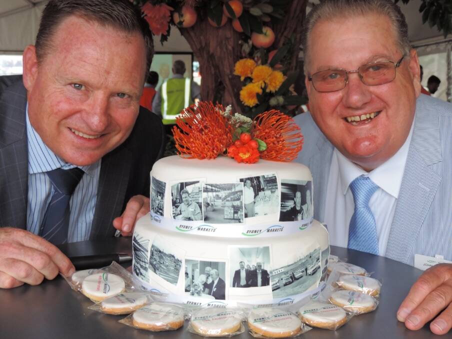 Sydney Markets CEO Brad Latham and chair John Pearson celebrate 40 years of the markets operating from its current location at Flemington. 