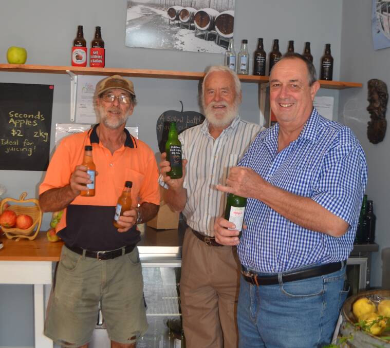 Ralph Wilson, Harald Tietze and Ray Billing enjoy a class of cider produced and bottled in Batlow