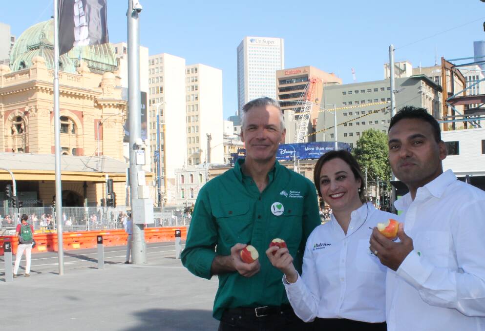 UNITED: National Farmers Federation chief executive officer, Tony Mahar, with Nutrien Ag Solutions staff Clare Darmanin and Lloyd Dias out selling the farming story with city workers in Melbournes Federation Square in November.