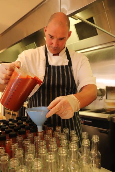CARE: Bottling the sauce by hand. 