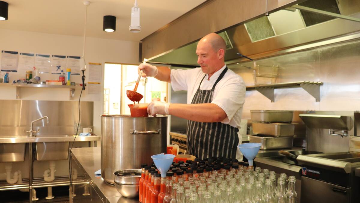HOT: Leigh Nash in his commercial kitchen at Sunshine Harvester Works, Fremantle, taking extra care preparing and bottling the sauce, wearing two sets of gloves.