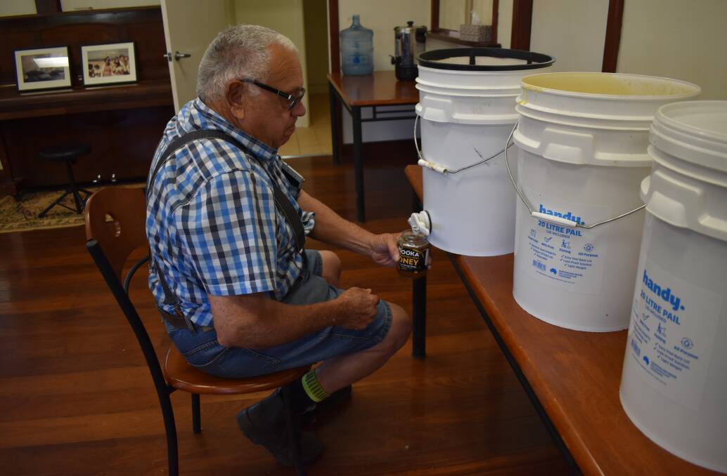 RESULT: Noongar Land Enterprise Group's beekeeper, Malcolm Clifford, pours the first batch of Ngooka Honey.