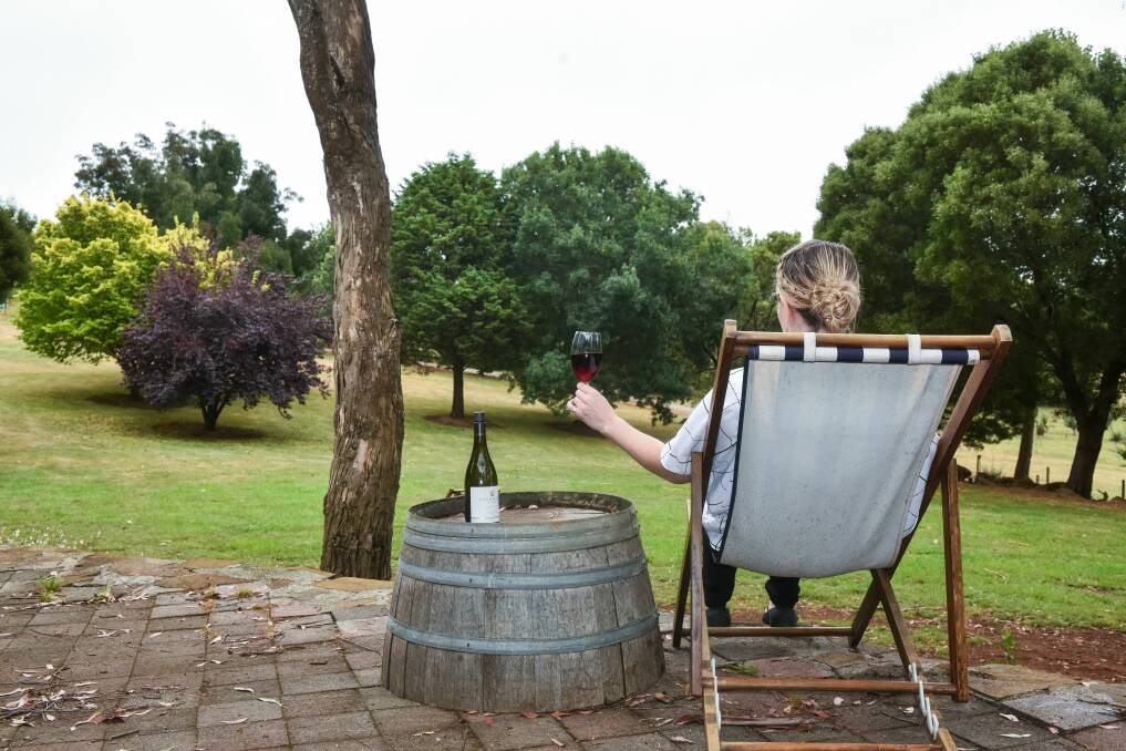 Enjoying a glass of wine at Delamere. The high quality and variety of wine on offer in Tasmania is bringing the state global attention. Picture: Neil Richardson