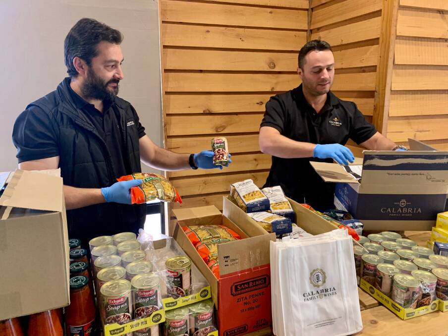 HELP: Michael and Andrew Calabria packing the Calabria Family Care Packs. Photo: Calabria Family Wines
