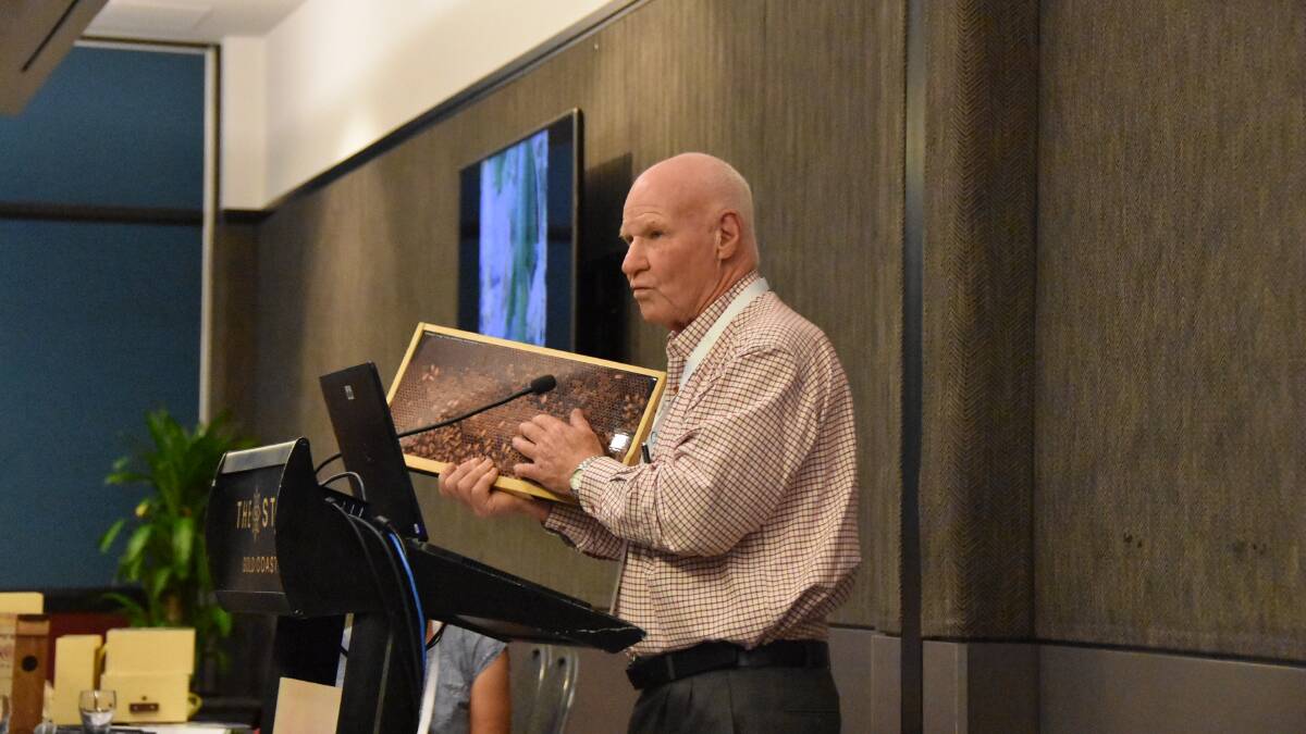 EXAMPLE: Beekeeper, Bruce White OAM, shows off what a frame may look like within a healthy hive. 