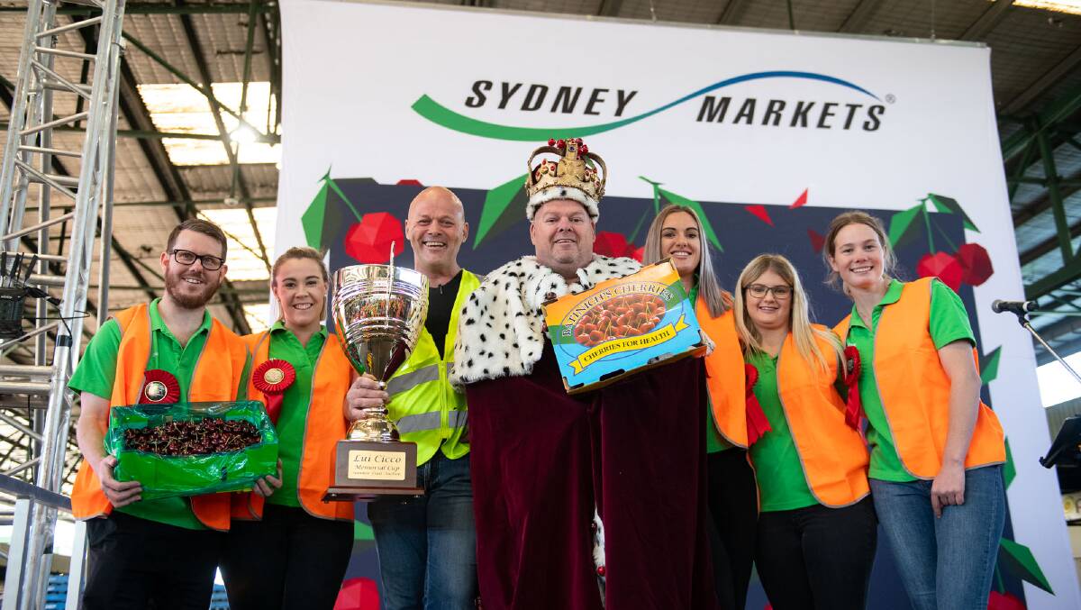 DONE: Young Cherry Festival King entrant David Munnerley (far left), and Cherry Queen entrants Laura Ower, Kate Cruickshank, Brianah Griffin. Tasman Coulter, with the Sydney Markets Cherry Auction top bidders, Shaun and Heath McInerney, The Fresh Fellas.