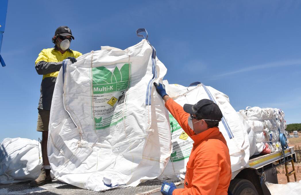 RECYCLING: Stephen hands another used Haifa bulk fertiliser bag up to Stewart for transfer into the baler. Haifa Australia was one of the first companies to sign up to FWRs stewardship program for fertiliser bag collection and has been a major advocate with other suppliers and producers to help ensure the industrys future environmental sustainability.