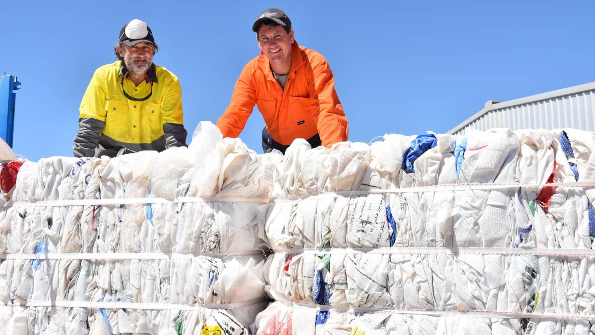 CRUNCHED: Stewart Ford and Stephen Richards, Farm Waste Recovery (FWR), with baled bulk fertiliser bags during a collection at Olams Menegazzo almond orchard in the Kenley area of Victorias Sunraysia region. Each bale comprises about 65 bags and weighs around 210 kilograms.