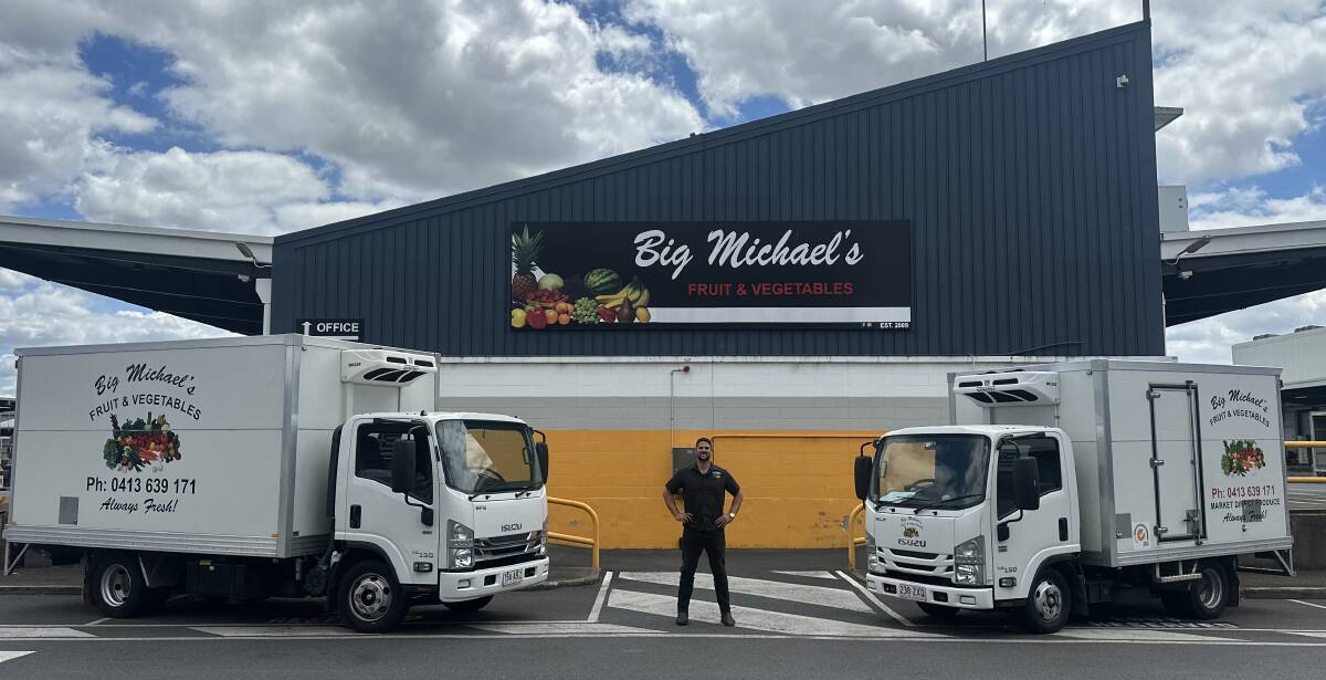 Big Michael's Fruit and Vegetables owner, Peter Marinos, with two of his delivery trucks outside the business's premises in Brisbane. Picture supplied