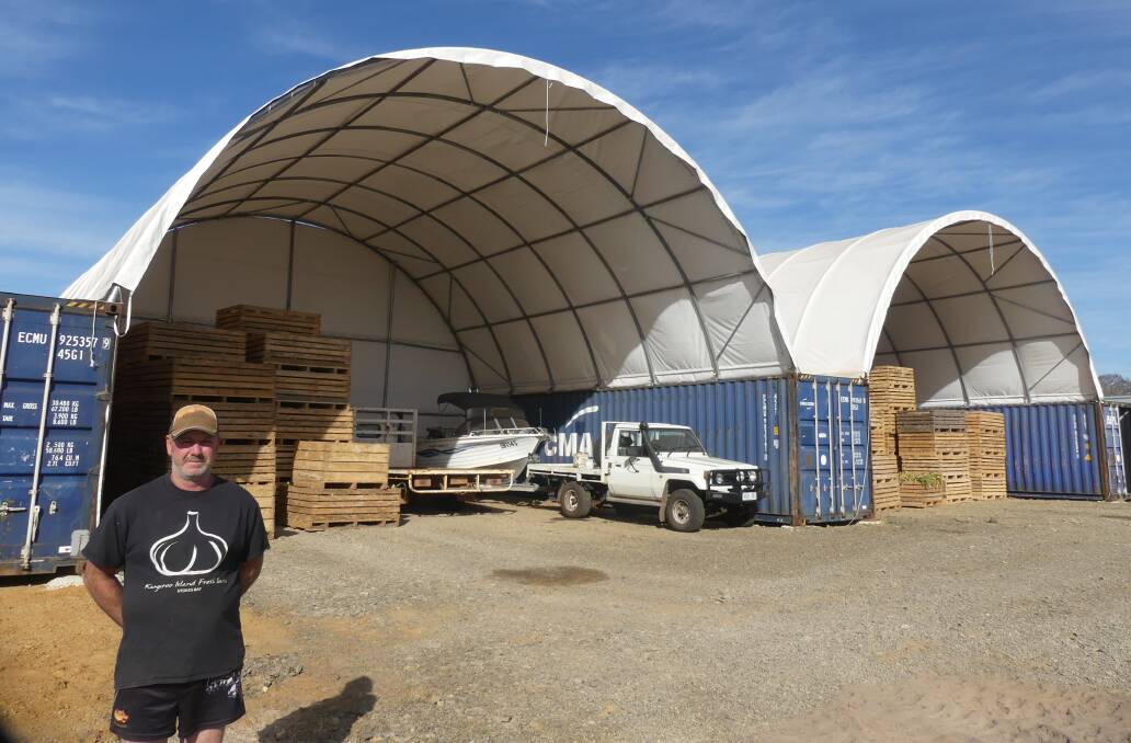 REBUILT: Shane Leahy and his new sheds packed full of garlic in January 2021. Picture: Stan Gorton 