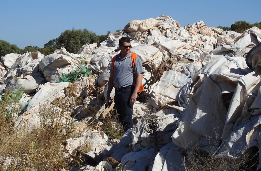 DUMPED: Stephen Richards, Farm Waste Recovery (FWR), pictured inspecting bulk fertiliser bags dumped at a local tip – bags that could have been recycled, rather than contributing to landfill.