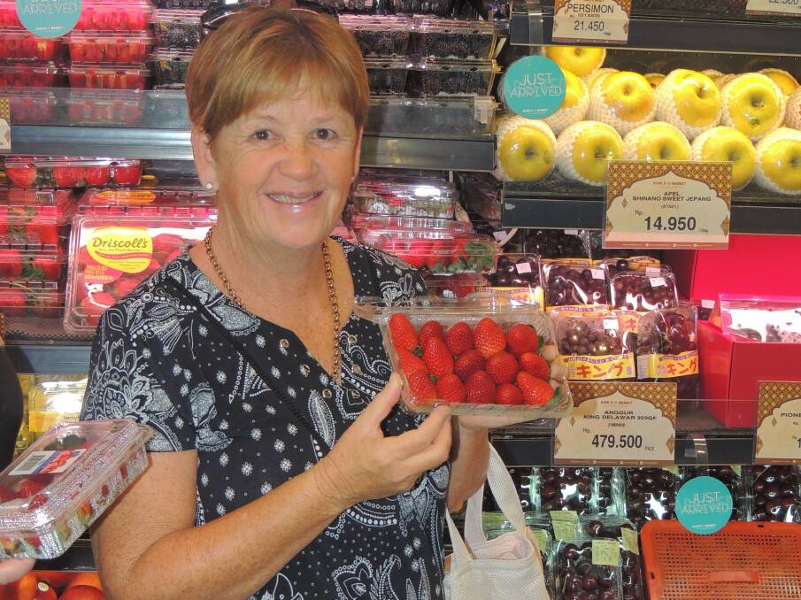 IN STOCK: Berry Patch Marketing's Charmaine Davey showing her fruit for sale at Ranch Market in Jakarta, Indonesia, as part of the Qld Strawberry Growers Association tour. 