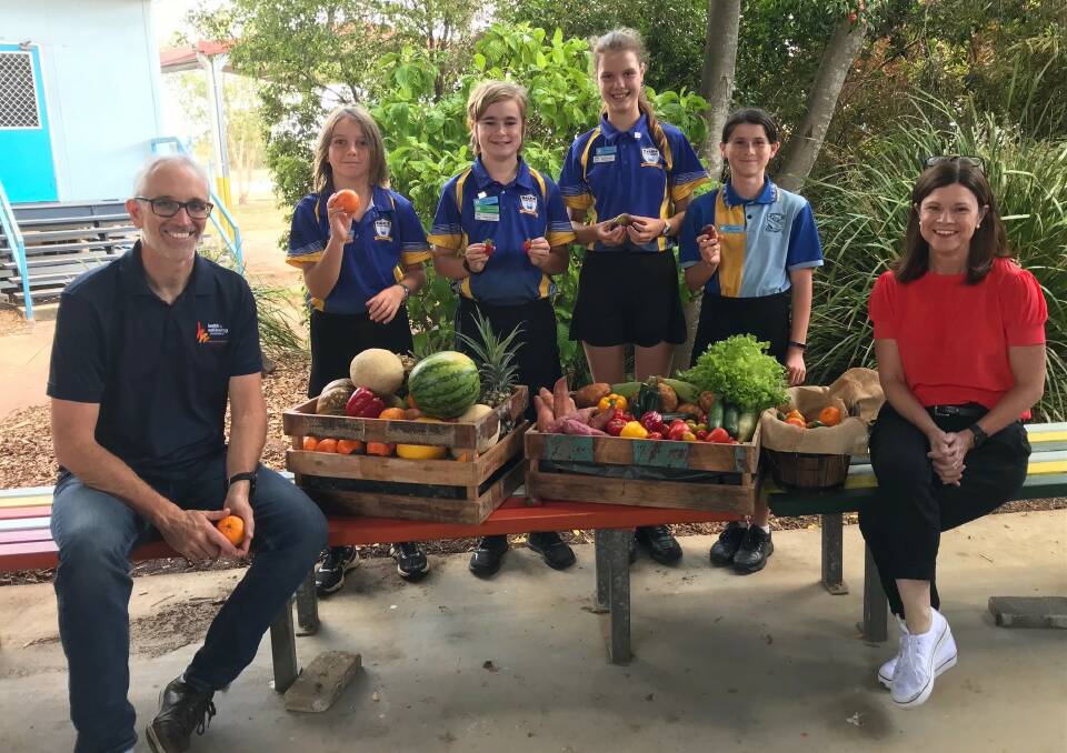 PICKED: Mat Dick, principal lead (Public Health Nutrition), Health and Wellbeing Queensland; Dr Robyn Littlewood, chief executive, Health and Wellbeing Queensland with some of the Kalkie State School children launching the Pick of the Crop program in Bundaberg. 