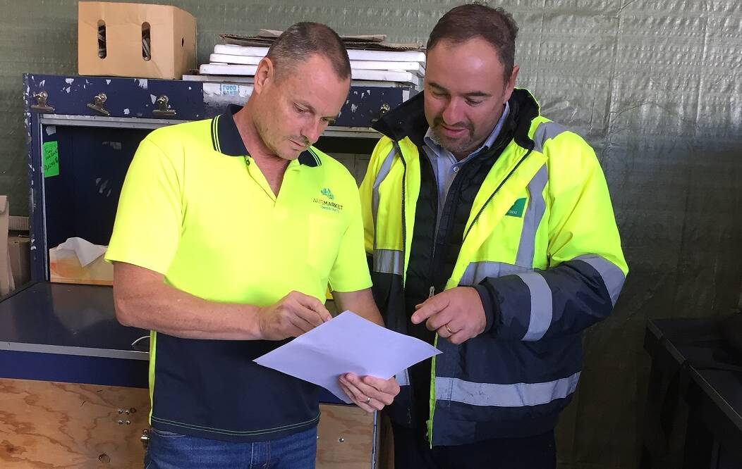 FIGURES: Market Information Services principal, Jon Brewer checks a report with George Valiotis, United Lettuce. MIS has been in operation for more than 25 years. 