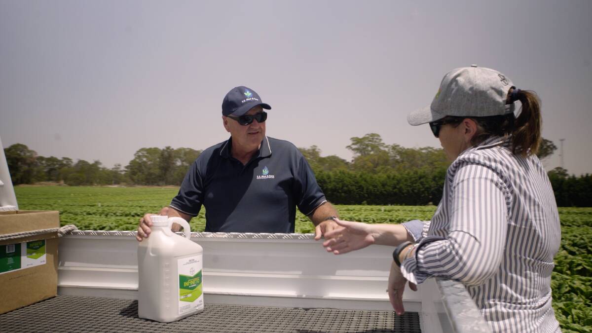 USE: Mark Rogers, EEM and Bayer Crop Science representative Carmen Brown discussing the benefits of Infinito fungicide.