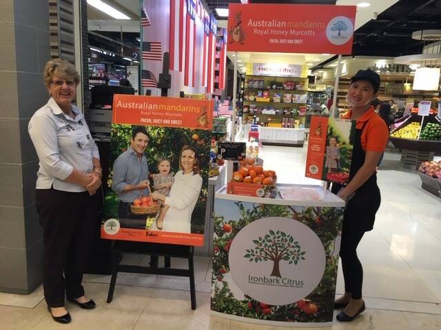 Susan Jenkin, Ironbark Citrus, Mundubbera helping promote Australian-grown mandarins within an Asian supermarket. Picture supplied