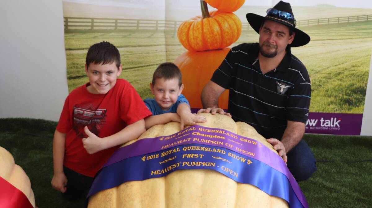 Tyler ( left), Jackson (Centre) and Steve Fritz (right) and the winning Giant Pumpkin.