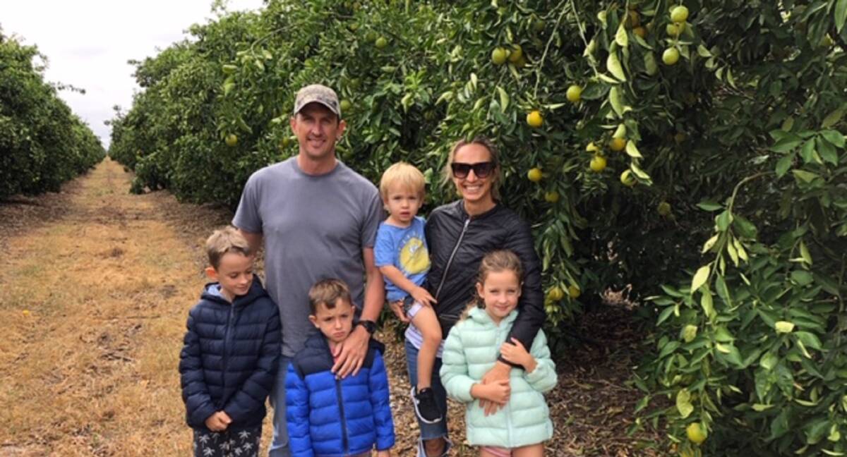 CONCERN: Archer Walters and his family at the Moree Valenica orchard owned by Grove Juice. "Figures show 75 per cent of Australians don't get their daily intake of fresh fruit and vegetables and orange juice is part of that."