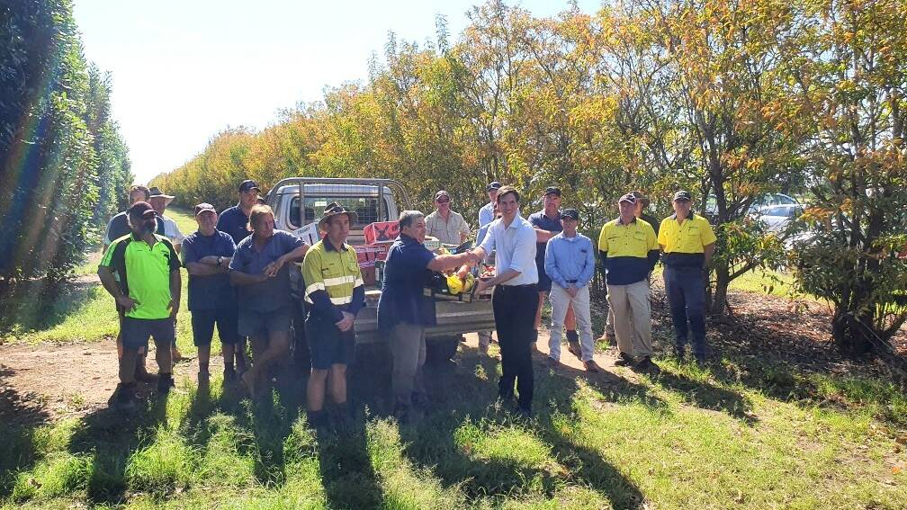 UP IN ARMS: A group of Bundaberg farmers gift Bundaberg MP Tom Smith with a basket of locally grown produce which they argue would be affected if a proposed coking coal mine would go ahead, north of Bundaberg. Photo: Supplied. 