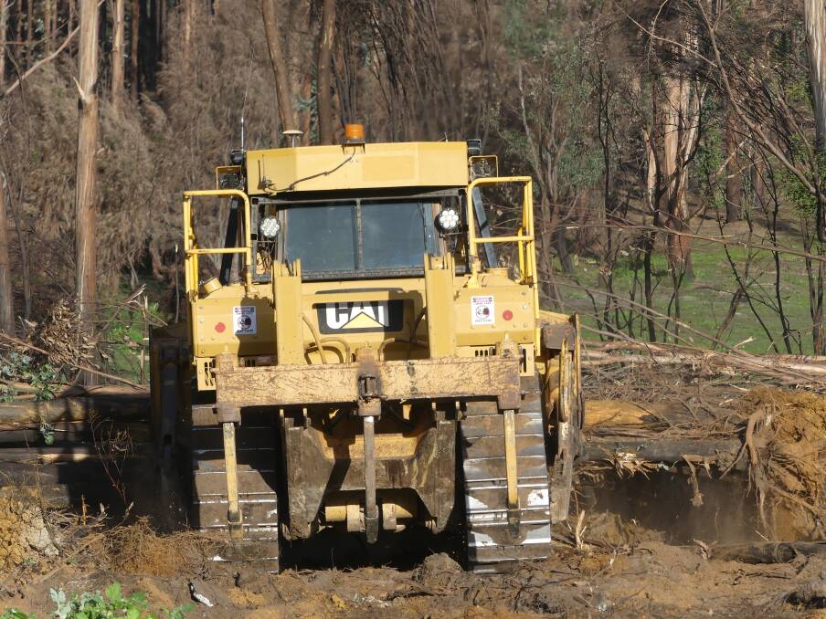 GONE: The D7 bulldozer at work removing damaged trees off Turkey Lane. 