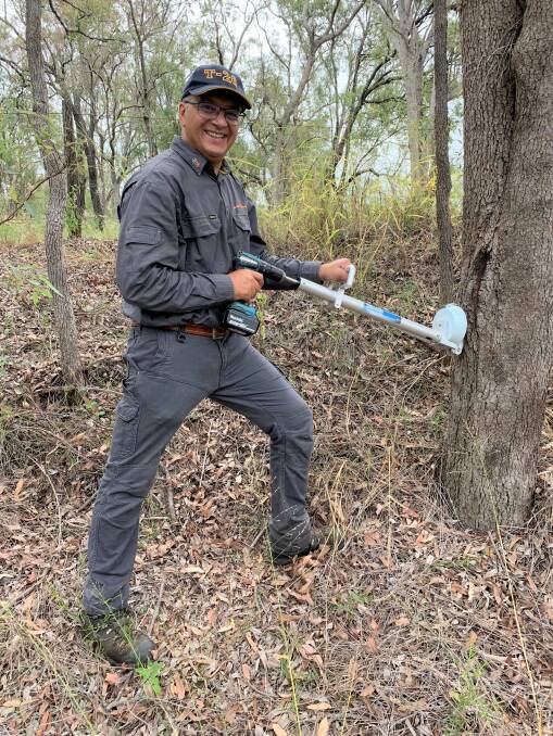 WEAPON: Professor Vic Galea with the new Injecta gun that can kill large invasive trees.