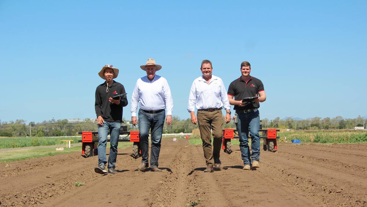 ON FARM: Agerris mechatronics engineer David Htet, Queensland agriculture minister Mark Furner, Kalfresh CEO Richard Gorman and Agerris robotics technician and operator Andrew Whiteside alongside two Agerris Digital Farmhands. Pictures: Melody Labinsky