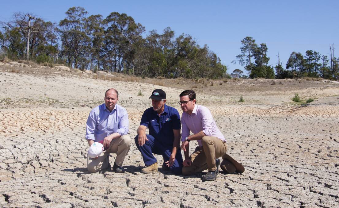 SUPPORT: Treasurer Josh Frydenberg, apple grower Dino Rizzato, and Drought Minister David Littleproud inspect Mr Rizzato's dam.