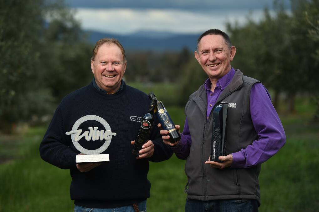 CHEERS: David Morris from Morris Wines and Rob Whyte from Gooramadda Olives celebrate their combined success. The two business owners are neighbours and mates and enjoy working side-by-side.Picture: MARK JESSER