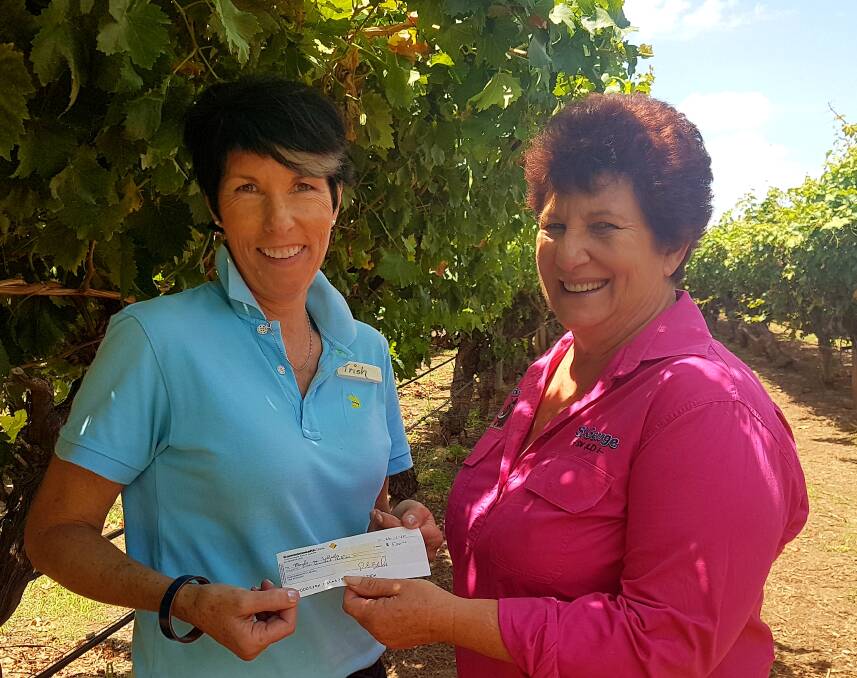 GIVING: Riversands cellar door manager Trish Jensen presenting the proceeds from
the event to Robyn Fuhrmiester on behalf of St George Meals on Wheels to
purchase hot box eskies for deliveries.