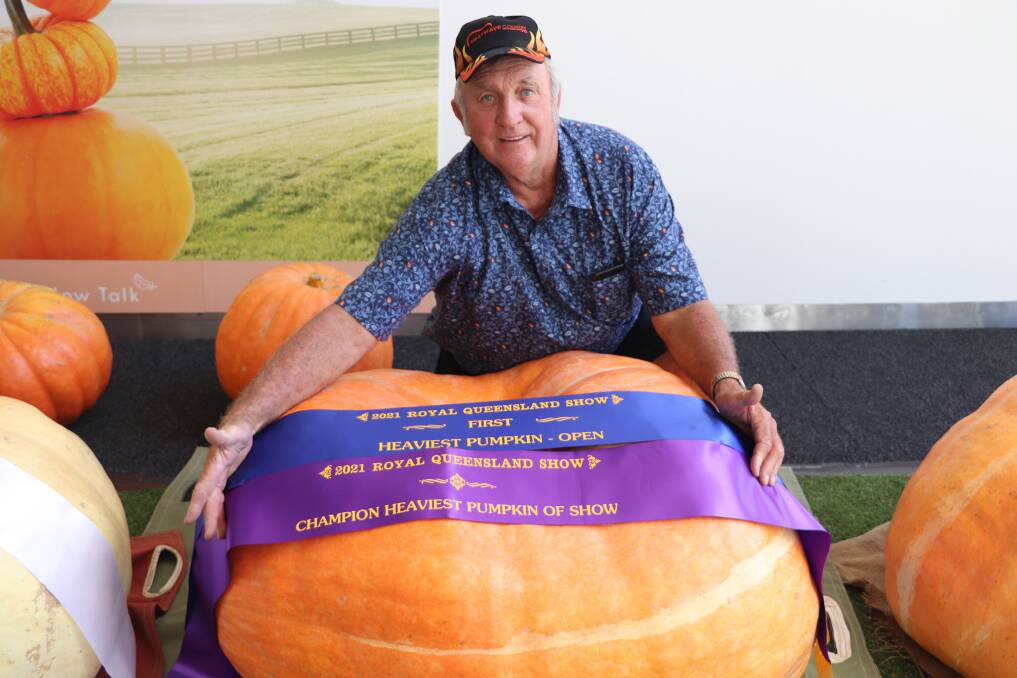 WINNER: Geoff Frohloff, Minden with his winning 196kg pumpking which claimed the top title at the Royal Queensland Show's Giant Pumpkin Competition.