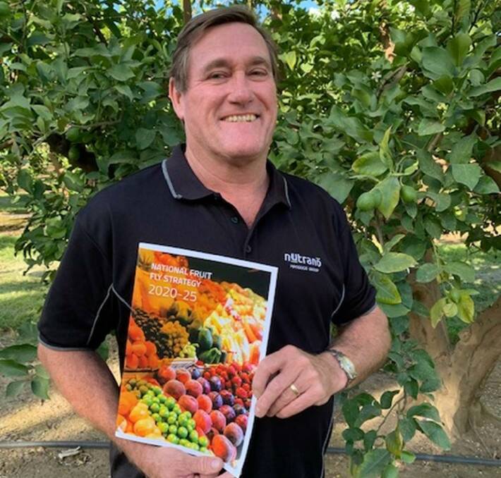 SUPPORT: Steve Burdette, technical manager at Nutrano Produce Group and NFFC member, with a copy of the 2020-25 National Fruit Fly Strategy.